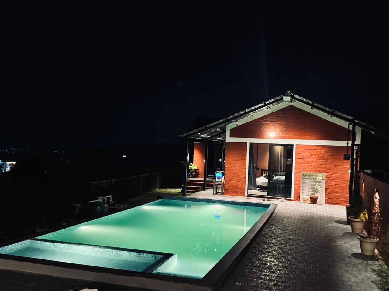 Nighttime luxury poolside ambiance at V-Farms private villa